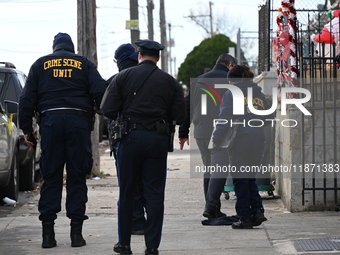 Philadelphia Police crime scene unit investigators are at the scene where one person is killed and four other people are injured in a mass s...