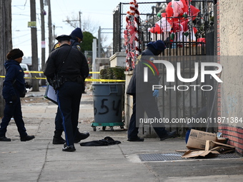 Philadelphia Police crime scene unit investigators are at the scene where one person is killed and four other people are injured in a mass s...