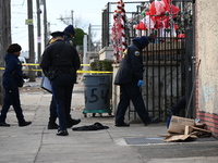 Philadelphia Police crime scene unit investigators are at the scene where one person is killed and four other people are injured in a mass s...