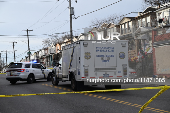 Philadelphia Police crime scene unit investigators are at the scene where one person is killed and four other people are injured in a mass s...