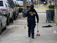 Philadelphia Police crime scene unit investigators are at the scene where one person is killed and four other people are injured in a mass s...