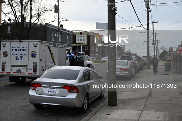 Philadelphia Police crime scene unit investigators are at the scene where one person is killed and four other people are injured in a mass s...