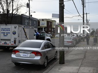 Philadelphia Police crime scene unit investigators are at the scene where one person is killed and four other people are injured in a mass s...