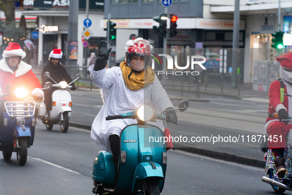 Dozen members of the Vespa club dress as Santa Claus and ride around downtown Cologne, Germany, on December 15, 2024. 