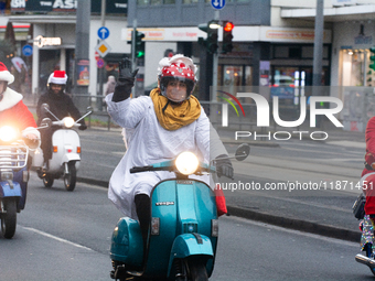 Dozen members of the Vespa club dress as Santa Claus and ride around downtown Cologne, Germany, on December 15, 2024. (