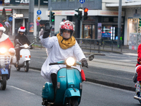 Dozen members of the Vespa club dress as Santa Claus and ride around downtown Cologne, Germany, on December 15, 2024. (