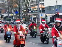 Dozen members of the Vespa club dress as Santa Claus and ride around downtown Cologne, Germany, on December 15, 2024. (