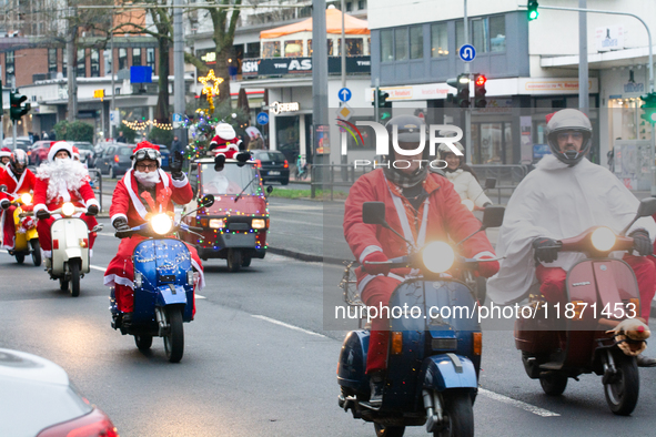 Dozen members of the Vespa club dress as Santa Claus and ride around downtown Cologne, Germany, on December 15, 2024. 