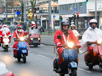 Dozen members of the Vespa club dress as Santa Claus and ride around downtown Cologne, Germany, on December 15, 2024. (