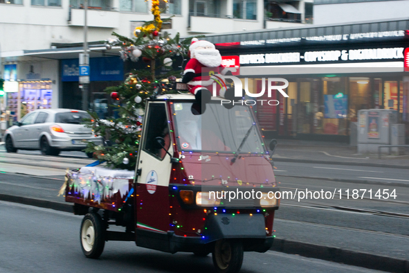 Dozen members of the Vespa club dress as Santa Claus and ride around downtown Cologne, Germany, on December 15, 2024. 