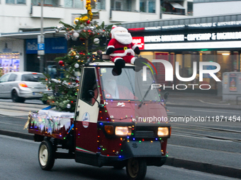 Dozen members of the Vespa club dress as Santa Claus and ride around downtown Cologne, Germany, on December 15, 2024. (