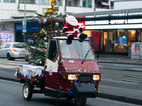 Dozen members of the Vespa club dress as Santa Claus and ride around downtown Cologne, Germany, on December 15, 2024. (