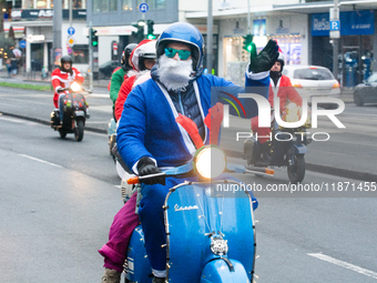 Dozen members of the Vespa club dress as Santa Claus and ride around downtown Cologne, Germany, on December 15, 2024. (