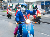 Dozen members of the Vespa club dress as Santa Claus and ride around downtown Cologne, Germany, on December 15, 2024. (