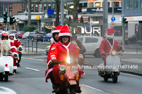 Dozen members of the Vespa club dress as Santa Claus and ride around downtown Cologne, Germany, on December 15, 2024. 