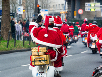 Dozen members of the Vespa club dress as Santa Claus and ride around downtown Cologne, Germany, on December 15, 2024. (