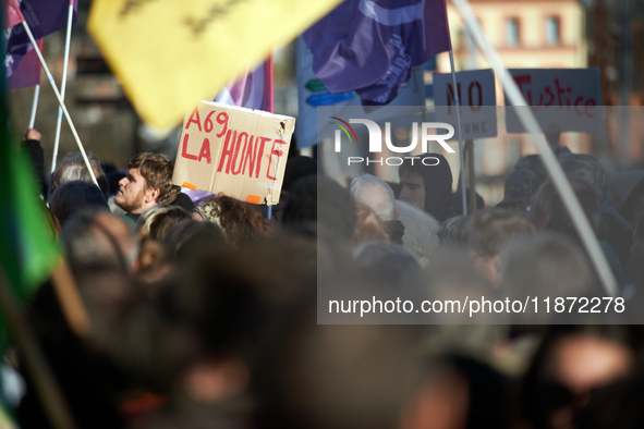 Amid the crowd, a placard reads 'Shame on the A69'. Between 100 and 1500 people gather in Toulouse, France, on December 15, 2024, against a...