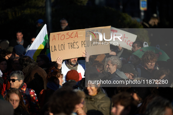 A protester holds a placard reading 'Atosca and State the law is not for them'. Between 100 and 1500 people gather in Toulouse, France, on D...