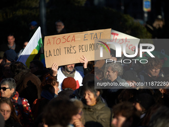 A protester holds a placard reading 'Atosca and State the law is not for them'. Between 100 and 1500 people gather in Toulouse, France, on D...