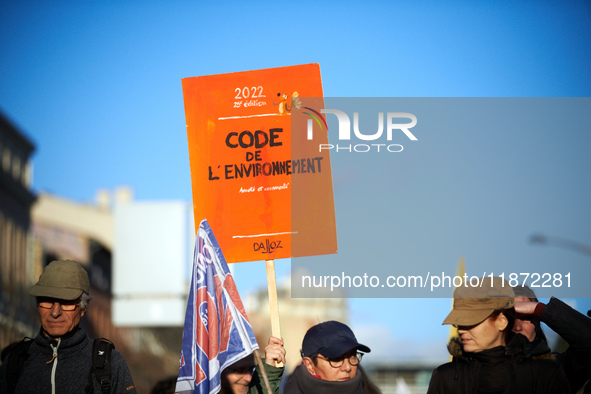 A protester holds a placard resembling the Code of the Environment. Between 100 and 1500 people gather in Toulouse, France, on December 15,...