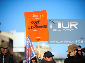 A protester holds a placard resembling the Code of the Environment. Between 100 and 1500 people gather in Toulouse, France, on December 15,...