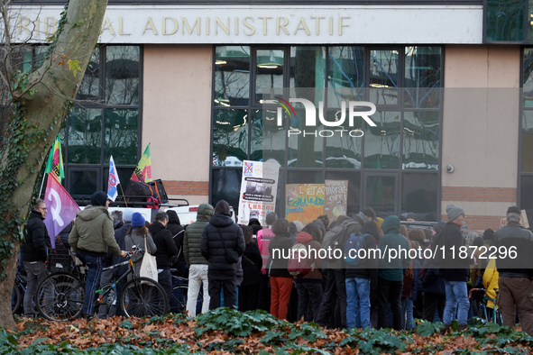 People stand in front of the Administrative Court while others speak. Between 100 and 1500 people gather in Toulouse, France, on December 15...