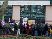 People stand in front of the Administrative Court while others speak. Between 100 and 1500 people gather in Toulouse, France, on December 15...