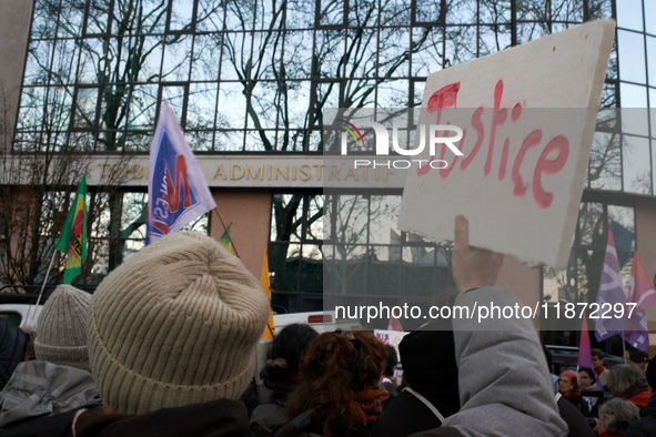 A protester holds a placard reading 'Justice' in front of the Administrative Court of Toulouse. Between 1,000 and 1,500 people gather in Tou...