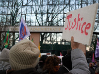 A protester holds a placard reading 'Justice' in front of the Administrative Court of Toulouse. Between 1,000 and 1,500 people gather in Tou...