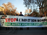 The banner reads 'Stop to the A69 and its world, another way is possible'. Between 1,000 and 1,500 people gather in Toulouse, France, on Dec...