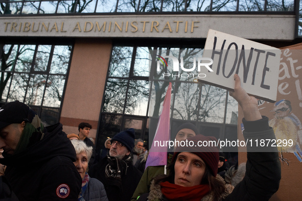 A woman holds a placard reading 'Shame' in front of the Administrative Court of Toulouse. Between 1,000 and 1,500 people gather in Toulouse,...