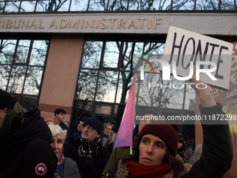 A woman holds a placard reading 'Shame' in front of the Administrative Court of Toulouse. Between 1,000 and 1,500 people gather in Toulouse,...