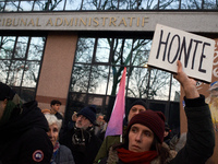 A woman holds a placard reading 'Shame' in front of the Administrative Court of Toulouse. Between 1,000 and 1,500 people gather in Toulouse,...