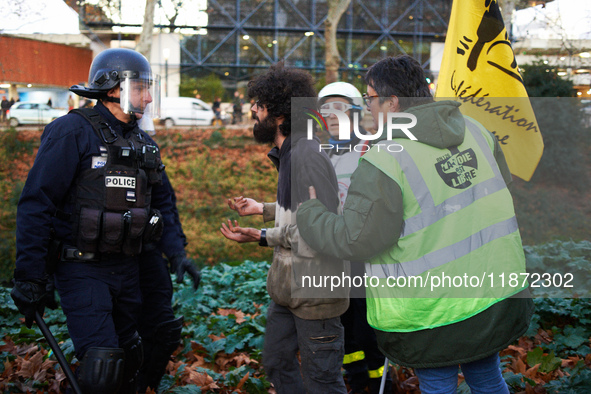 A protester argues with a riot policeman to recover his bag. Between 1,000 and 1,500 people gather in Toulouse, France, on December 15, 2024...