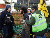 A protester argues with a riot policeman to recover his bag. Between 1,000 and 1,500 people gather in Toulouse, France, on December 15, 2024...