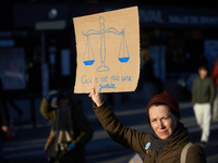 A protester holds a placard depicting the balance of justice and reading 'this is not justice'. Between 100 and 1500 people gather in Toulou...