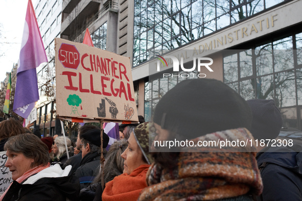 A woman holds a placard reading 'Stop to unlawful project' in front of the Administrative Court of Toulouse. Between 1,000 and 1,500 people...