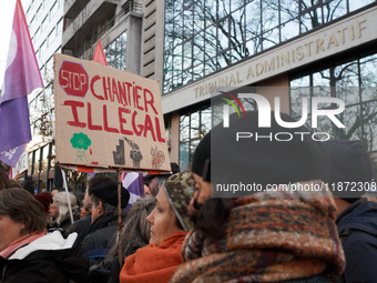 A woman holds a placard reading 'Stop to unlawful project' in front of the Administrative Court of Toulouse. Between 1,000 and 1,500 people...