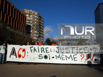 The banner reads 'A69: justice must be done by ourselves?' Between 1,000 and 1,500 people gather in Toulouse, France, on December 15, 2024,...