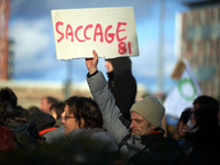 A man holds a placard reading 'Ransacking'. Between 1,000 and 1,500 people gather in Toulouse, France, on December 15, 2024, against a non-a...