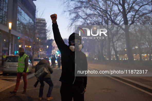 A protester raises his fist after riot police use tear gas. Between 1,000 and 1,500 people gather in Toulouse, France, on December 15, 2024,...