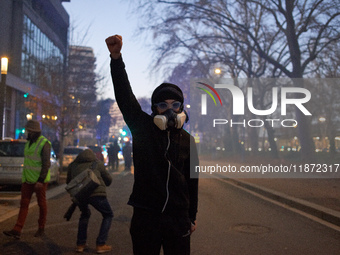 A protester raises his fist after riot police use tear gas. Between 1,000 and 1,500 people gather in Toulouse, France, on December 15, 2024,...