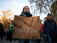 A young woman holds a placard reading 'Justice, come with us'. Between 1,000 and 1,500 people gather in Toulouse, France, on December 15, 20...