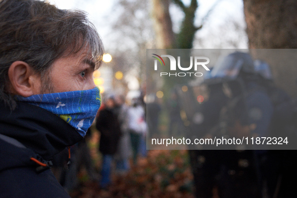 An angry protester looks at riot policemen near the Administrative Court of Toulouse. Between 1,000 and 1,500 people gather in Toulouse, Fra...