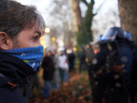 An angry protester looks at riot policemen near the Administrative Court of Toulouse. Between 1,000 and 1,500 people gather in Toulouse, Fra...