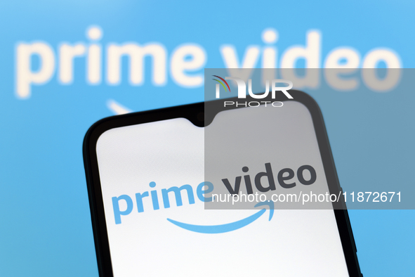 The Amazon Prime Video logo appears on the screen of a smartphone and in the background on the computer screen in Reno, United States, on De...