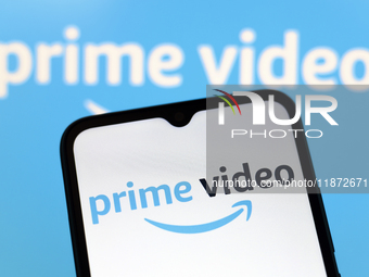 The Amazon Prime Video logo appears on the screen of a smartphone and in the background on the computer screen in Reno, United States, on De...