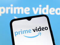 The Amazon Prime Video logo appears on the screen of a smartphone and in the background on the computer screen in Reno, United States, on De...