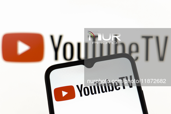 The YouTube TV logo appears on the screen of a smartphone and in the background on the computer screen in Reno, United States, on December 1...