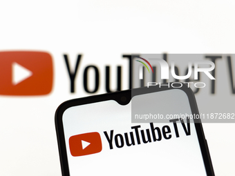 The YouTube TV logo appears on the screen of a smartphone and in the background on the computer screen in Reno, United States, on December 1...